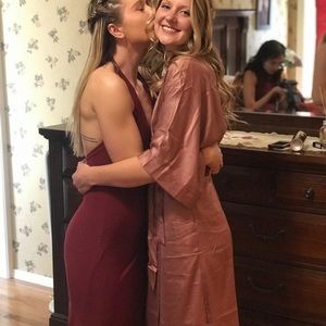 Red, floor length dress with high slit.